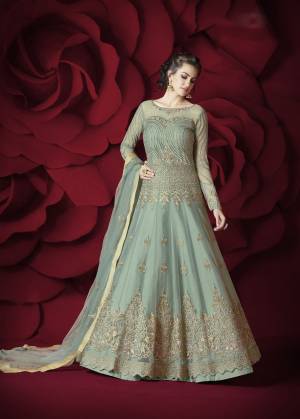 Very Lovely Shade In Blue Is Here With This Designer Floor Length Suit In Aqua Blue Color Paired With Aqua Blue Colored Bottom And Dupatta. Its Top Is Fabricated On Net Paired With Silk Bottom And Net Dupatta. It Is Beautified With Embroidery All Over. Buy This Designer Suit Now.