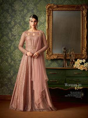 Catch All The Lime light Wearing This Designer Floor Length Suit In Dusty Pink Color Paired With Dusty Pink Colored Bottom And Dupatta. Its Heavy Attractive Top Is Fabricated On Jacquard Net Paired With Santoon Bottom And Net Fabricated Dupatta. It Is Beautified with Attractive Same Colored Pearls. Buy Now.