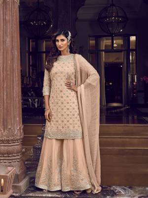 Flaunt Your Rich And Elegant Taste In This Very Pretty Heavy Designer Sharara Suit In Peach Color. Its Top, Bottom and Dupatta Are Fabricated On Georgette Beautified With Attractive Detailed Embroidery. Buy Now.