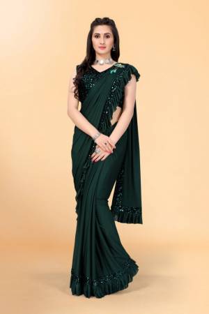 Get glowing in this pretty ready-to-wear lycra saree. The saree is made of lycra fabric with ruffles detailing on hem beautified by diamonds border which attracts the crowd. This saree comes along with unstitched velvet diamond embellished fabric blouse piece. It is perfect for parties, family functions when paired with beautiful jewellery and pair of heels to complete the look.
