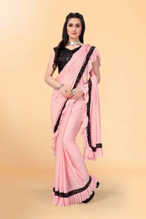 Get glowing in this pretty ready-to-wear lycra saree. The saree is made of lycra fabric with ruffles detailing on hem beautified by diamonds border which attracts the crowd. This saree comes along with unstitched velvet diamond embellished fabric blouse piece. It is perfect for parties, family functions when paired with beautiful jewellery and pair of heels to complete the look.