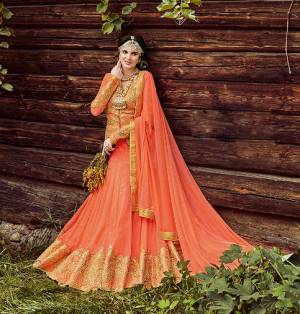 Indulge Yourself In The Wedding Fiesta! Grab This Light Orange Colored Designer Lehenga Choli And Look Divalicious For Your Special Day. This Beauteous Lehenga Choli Is Featured With Stone Work Designs and Cut Work.