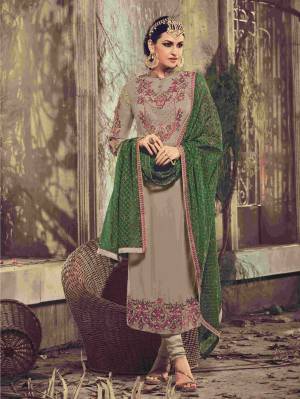 Add This Unique Colored Suit To Your Wardrobe. A Perfect Blend Of Two Opposite Colors Has Been Used In This Suit. This Grey Colored Suit Is Paired With Green Colored Dupatta Looks More Beautiful When You Wear It. Buy This Suit Now.