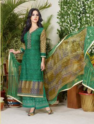 Grab This Green Colored Suit Fabricated On Cotton With Beautiful Print And Thread Embroidery Over The Neckline. This Dress Material Is For Casual Wear And You Can Make This Stitch As Plazzo Or Pants. Buy This Now.