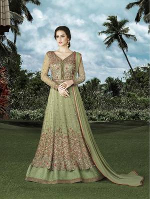 This Season Go With Sorbet Shades In Your Wardrobe. Grab This Mint Green Colored Floor Length Suit Fabricated On Net With Heavy Jari And Thread Embroidery And Stone Work All Over The Top. Buy This Suit Now.