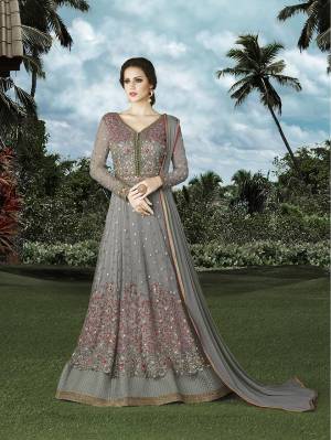 Get Ready For The Next Funxtion At Your Place With This Grey Colored Floor Length Suit Fabricated On Net. Its Bottom Is Fabricated On Santoon And Dupatta Is Fabricated On Chiffon. This Suit Is Light In Weight So That You Can Carry It Throughout The Gala.