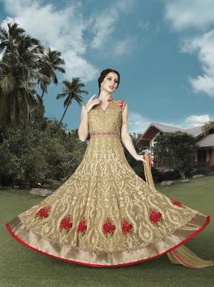 Look Simply Elegant In This Beige Colored Suit Fabricated On Net Beautified With Detailed Embrioidery All Over The Top  Paired With Beige Colored Bottom And Dupatta Fabricated On Santoon And Net Respectively. Earn Lots Of Compliments Wearing This Designer Floor Length Dress. 