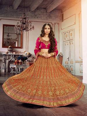 Enhance Your Ethenic Look With New Collection In Heavy Lehengas. Grab This Orange Colored Lehenga Paired With Rani Pink Colored Blouse And Dupatta. This Lehenga is Beautified Witgh Heavy Embroidery All Over. Grab This Heavy Lehenga For The Next Wedding At Your Place.
