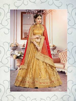 Look Elegant In This Beige Colored Lehenga And Blouse Paired With Red Colored Dupatta. This Pretty Lehenga Choli Is Fabricated On Net Jacquard With Net Dupatta. Grab This Pretty Lehenga And Add This To Your Wardrobe Now.