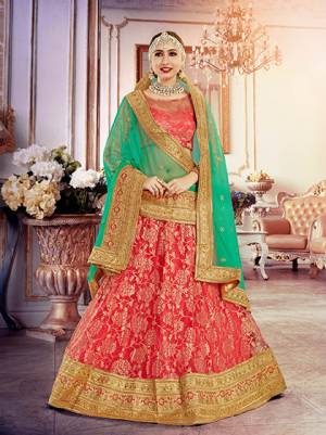 Catch All The Limelight At The Next Wedding You Attend. The Attractive Crimson Red Colored Colored Lehenga Choli Will Make You Look The Most Beautiful Of All Paired With Sea Green Colored Net Fabricated Dupatta. This Lehenga Choli Is Beautified With Heavy Embroidery And And Lace Borders. Grab This Designer Lehenga Choli Now.