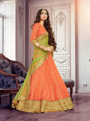 Add This Traditional Lehenga Choli Dress To Your Wardrobe In Bright Orange Colored Paired With Lime Green Colored Dupatta. This Lehenga Has A Beautiful Inner Fabric With Jute Print All Over. This Lehenga Is Easy To Carry And Esy To Care For. Buy This Designer Lehenga Choli Now.
