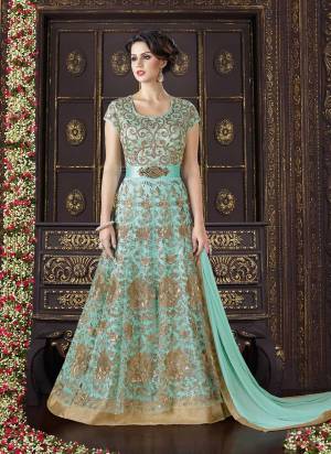 Doll Up Yourself With This Unique Colored Floor Length Suit. This Aqua Blue Colored Suit Is Paired With Aqua Blue Colored Bottom And Dupatta. This Pretty Suit Is Fabricated On Net Beautified With Heavy Jari Embroidery And Sequence Work. Pair This Up With Golden Earrings And Complete Your Amazing Look.