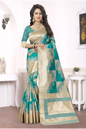 A Very Unique Combination In Saree Is Here. Adorn This Teal Green And Beige Colored Saree Paired With Green Colored Blouse. This Saree Is Fabricated On Kanjivaram Art Silk. Buy This Pretty Saree Now.