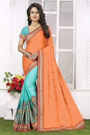 Grab This Contrasting Colored Saree In Light Orange And Aqua Blue  Which Is Paired With Aqua Blue Colored Blouse. This Designer Saree Is Fabricated On Crepe Silk. This Saree Is Beautified With Jari And Thread Embroidery With Coding Lace Border. Buy This Saree Now. 