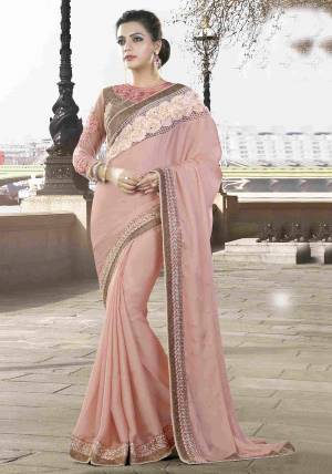 There Is A Unique Sophistication In Soft Shades. Look Dainty And LadyLike In This Pretty Baby Pink Colored Saree  Paired With Brown Colored Blouse As You Sashay Around The Next Soiree. 