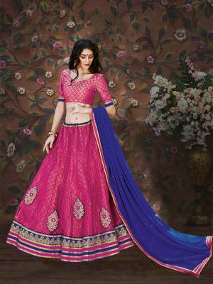 Shine Bright With This Pink Colored Lehenga Choli Paired With Blue Colored Dupatta. Its Blouse Is Fabricated On Brocade Paired With Net And Brocade Fabricated Lehenga With Chiffon Dupatta. Buy This Pretty Lehenga Now.