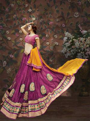 Bright And Visually Appealing, Here Is A Pretty Magenta Pink Colored Lehenga Choli Paired With Contrasting Yellow Colored Dupatta. Its Blouse Is Fabricated On Brocade Paired With Net And Brocade Fabricated Lehenga And Chiffon Dupatta. All Fabrics Ensures Great Comfort Throughout The Gala. Buy Now.