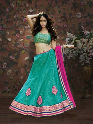 Celebrate This Festive Season With This Pretty Sea Green Colored Lehenga Choli Paired With Rani Pink Colored Dupatta. Its  Brocade Blouse Is Paired With Net And Brocade Fabricated Lehenga With Chiffon Dupatta. Buy Now.