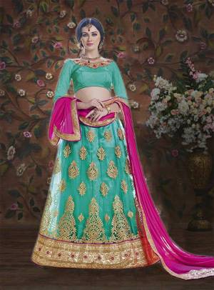This Wedding Season Get The Traditonal Look On Yourself With This Lovely Sea Green Colored Lehenga Choli Paired With Contrasting Rani Pink Colored Blouse. Its Blouse Is Fabricated On Art Silk Paired With Net Fabricated Lehenga And Chiffn Dupatta. Buy It Now.