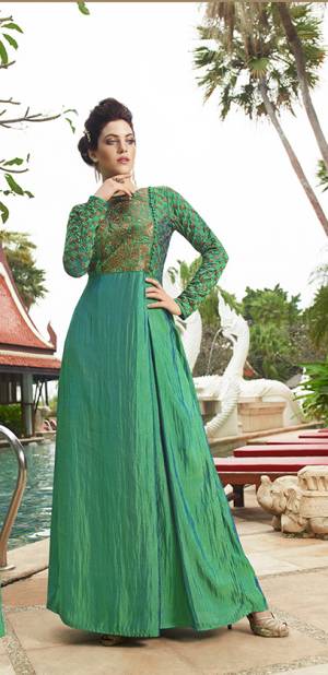 Grab This Trendy Green Colored Readymade Gown Fabricated On Satin Silk. This Designer Gown Is Beautified With Embroidery Over The Yoke And Full Sleeves. Buy This Gown Now.
