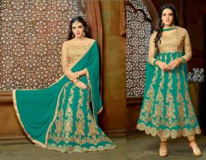 Celebrate This Festive Season Your Favourite Green Colored Attire.Its Top And Bottom Are In Beige Color Paired With Green Colored Lehenga And Dupatta. Get This Lovely Suit Stitched Into An Anarkali Or As A Lehenga Choli. It Is Light In Weight And Easy To Carry Throughout The Gala.