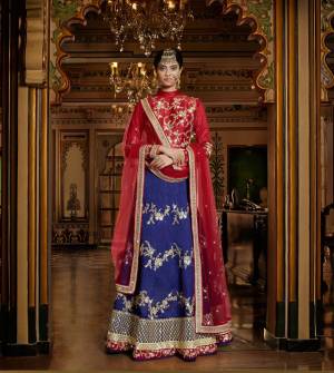 Get Ready For The Next Wedding At Your Place With This Beautiful Lehenga Choli. Its Red Colored Blouse Is Paired With Blue Colored Lehenga And Red Colored Dupatta. This Pretty Lehenga Choli Is Fabricated On Art Silk And Net Fabricated Dupatta. Grab This Designer Lehenga Choli Now.