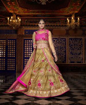 Look Beautiful In This Designer Lehenga Choli In Dark Pink Colored Blouse Paired With Beige Colored Lehenga And Dupatta. This Lehenga Choli Is Fabricated On Art Silk Paired With Net Dupatta And Beautified With Heavy Floral Embroidery All Over. Buy This Lehenga Choli Now. 