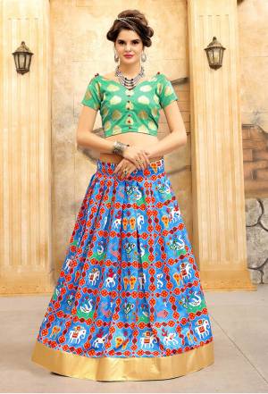 Go Colorful Wearing This Lehenga Choli In Sea Green Colored Blouse Paired With Turquoise Blue Colored Lehenga And Red Colored Dupatta. Its Lehenga Is Beautified With Folk Prints. Buy This Colorful Lehenga Choli Now. 