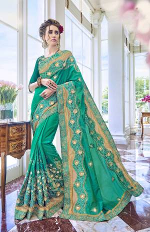 Grab This Beautiful Shade Of Green In This Teal Green Colored Saree Paired With Teal Green Colored Blouse. This Saree And Blouse are Fabricated On Art Silk. Its Beautiful New Shade And Attractive Embroidery Will Earn You Lots Of Compliments From Onlookers.