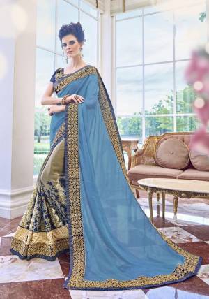 Add This Beautiful Designer Saree To Your Wardrobe In Blue And Grey Color Paired With Navy Blue Colored Blouse. This Saree Is Fabricated On Chiffon And Georgette Paired With Art Silk Fabricated Blouse. It Is Beautified With Heavy Embroidery Over The Panel And Lace Border.