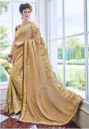 Flaunt Your Rich And Elegant Taste Wearing This Saree In Beige Colored Paired With Dark Brown Colored Blouse. This Saree Is Fabricated On Art Silk And Georgette Paired With Art Silk Fabricated Blouse. It Has Heavy Attractive Embroidery With 3D Flowers All Over Its Border.