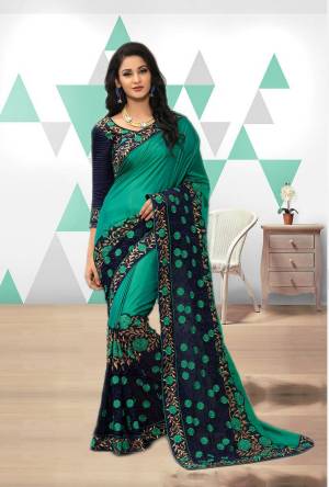 New Shade Of Green Is Here With This Saree In Teal Green And Navy Blue Color Paired With Navy Blue Colored Blouse. This Saree Is Fabricated On Art Silk And Georgette Paired With Art silk And Net Fabricated Blouse.  It Is Beautified With Heavy Embroidery. Buy This Pretty Saree Now.