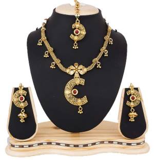 This Wedding Season Grab a Little More Attention Towards Your Jewellery With This Attractive Necklace Set In Golden Color Beautified With Maroon Colored Stones. This Necklace Set Is Light In Weight And Easy To Carry Throughout The Gala.