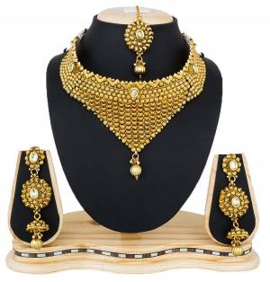 Enhance Your Neckline Wearing This Beautiful Golden Colored Heavy Necklace Set Pairing It Up With Any Colored Lehenga Choli Or Floor Length Suit. Buy This For The Upcoming Wedding Season. 