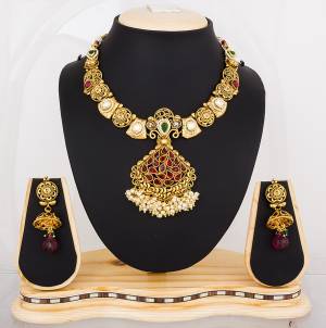 Here Is A Proper Traditonal Necklace Set In Golden Color Beautified With Multi Colored Stones. This Lovely Set Can Be Paired With Any Contrasting Colored Attire. Buy Now.