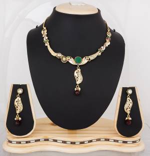 Pretty Simple Necklace Set Is Here Golden Color Beautified With Multi Colored Stones. This Pretty Set Has Green And Maroon Colored Stones. It Is Light In Weight And Easy To Carry All Day Long.