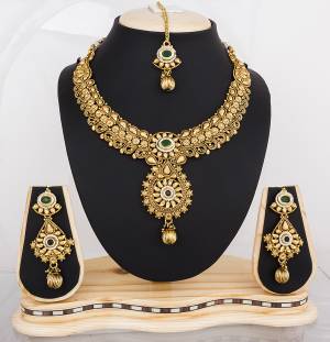 Grab This Designer Necklace Set In Golden Color Beautified With Dark Green Colored Stones. This Necklace Set Will Give A Heavy And Attractive Look To Your Personality. Buy It Now.