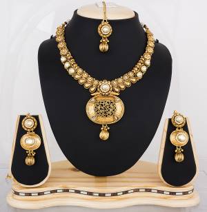 Heavy Looking Necklace Set Is Here In Golden Color Beautified With White Colored Stones. This Lovely Set Can Be Paired With any Colored Traditional Attire. Buy It Now.