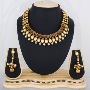 For That Queen Look, Grab This Attractive Necklace Set In Golden Color Beautified With White And Maroon Colored Stones. This Necklce Set Will Definitely Earn You Lots Of Compliments From Onlookers. Buy It Now.