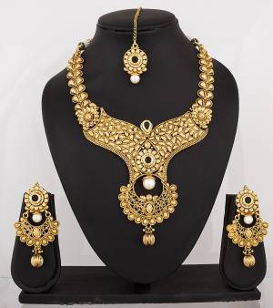 Get Ready For The Next Wedding Season With This Attractive And Heavy Necklace Set In Golden Color Which Can Be Paired Colored Traditonal Attire.  Buy This Designer Necklace Set Now.
