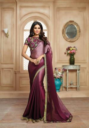 Add The Most Lovely Color To Your Wardrobe With This Designer Saree In Two Shades Of Wine Paired With Dark Wine Colored Blouse. This Rich Looking Saree Is Fabricated On Satin Paired With Art Silk Fabricated Blouse. It Has Heavy Embroidery All Over The Blouse And Saree Lace Border. Buy This Saree Now.