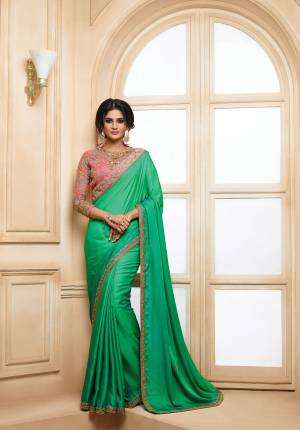 Look Beautiful Wearing This Designer Saree In Green Color Paired With Contrasting Dark Peach Colored Blouse. This Saree Is Fabricated On Satin Paired With Art Silk And Net Fabricated Blouse. Its Pretty Colors And Embroidery Will Give You A Unique Look To Your Personality.