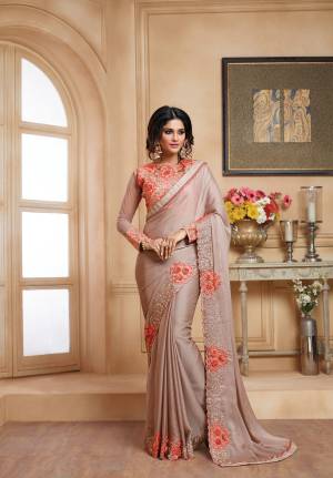 Flaunt Your Rich And Elegant Taste Wearing This Saree In Pale Grey Color Paired With Contrasting Orange Colored Blouse. This Saree Is Fabricated On Chiffon Paired With Art Silk And Net Fabricated Blouse. It Has Beautiful Contrasting Embroidery Over The Lace Border And Blouse. 