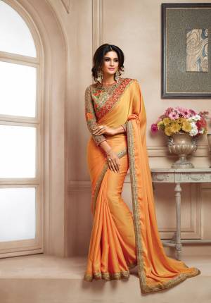 Orange Color Induces Perfect Summery To any Outfit So Grab This Designer Saree In Orange Color Paired With Contrasting Mint Green Colored Blouse. This Saree Is Fabricated On Satin Paired With Art Silk And Net Fabricated Blouse. This Attrctive Saree Will Earn You Lots Of Compliments From Onlookers.
