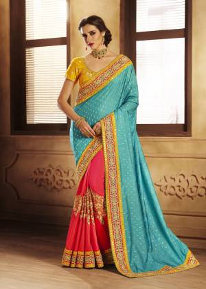 Grab This Colorful Attractive Designer Saree In Blue And Fuschia Pink Color Paired With Contrasting Yellow Colored Blouse. This Saree Is Fabricated On Jacquard Silk And Handloom Art Silk Beautified With Embroidery All Over. It Is Easy To Drape And Also Easy To Carry Throughout The Gala.