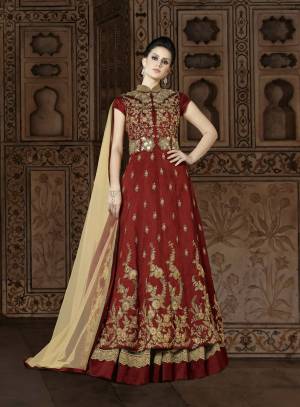 Adorn The Lovely Queen Look Wearing This Designer Floor Length Suit In Maroon Color Paired With Beige Colored Lehenga And Dupatta. Its Top Is Fabricated On Art Silk Paired With Net And Santoon Fabricated Lehenga And Net Fabricated Dupatta. This Designer Indo-Western Dress Will Give Your Personality An Attractive Look. Buy Now.