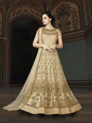 Flaunt Your Rich And Elegant Taste Wearing This Designer Floor Length Suit In Cream Color Paired With Cream Colored Bottom And Dupatta. Its Top Is Fabricated On Net Paired With Santoon Bottom And Chiffon Dupatta. Its Beautiful Yoke Pattern Will Earn You Lots Of Compliments From Onlookers.