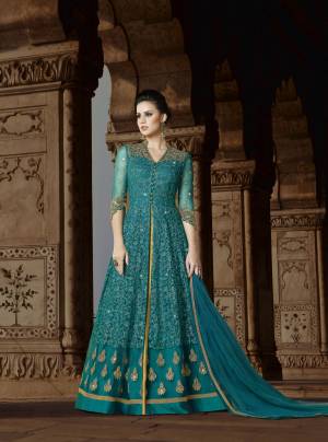 Celebrate This Festive Season With This Lovely Designer Floor Length Suit In Green Color Paired With Golden Colored Lehenga And Green Colored Dupatta. Its Top Is Fabricated On Net Paired With Art silk Lehenga And Net Dupatta. It Top Has Heavy Embroidery All Over It. Buy This Soon Before The Stock Ends.