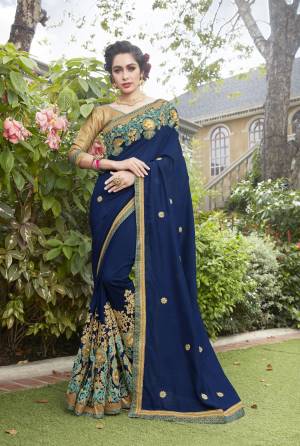 Celebrate This Festive Season With This Attractive Designer Saree In Blue Color Paired With Golden Colored Blouse. This Saree Is Fabricated On Cotton Silk Paired With Art Silk Fabricated Blouse. It Has Heavy Embroidery Over The Border. Buy Now.