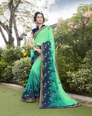 Look Pretty Wearing This Saree In Lovely Shade Of Green With This Sea Green Colored Saree Paired With Contrasting Blue Colored Blouse. This Saree Is Fabricated On Silk Georgette Paired With Art Silk Fabricated Blouse. It Has Contrasting Blue Colored Embroidery Over The Saree.